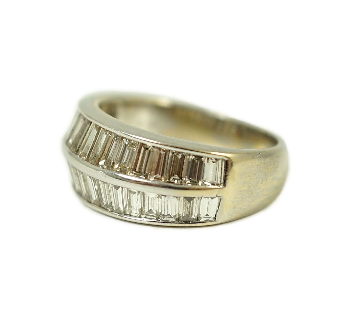 A modern 18k white gold and two row graduated baguette cut diamond set half hoop ring